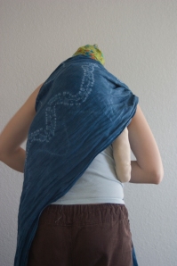 4.  Place the rebozo pass  across your baby's back.